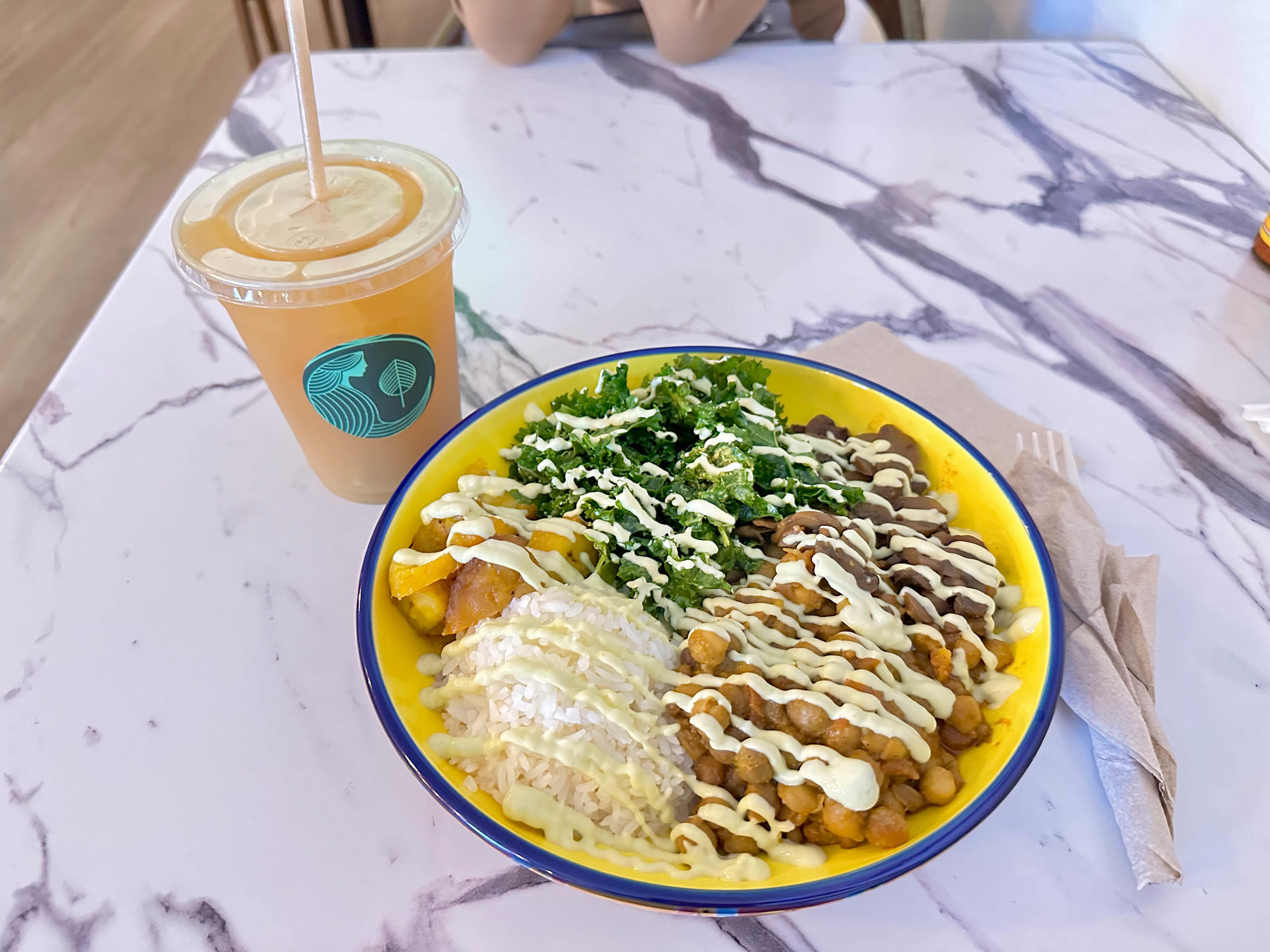 marble table with vegan bowl and drink